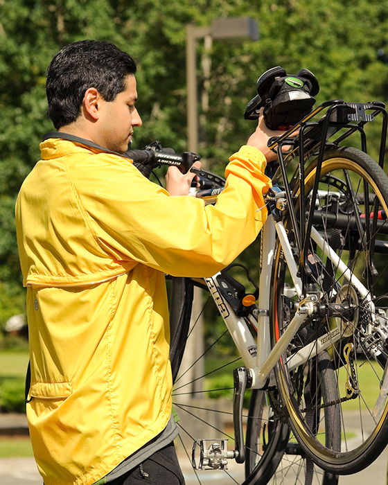 Van pool rider mounting bike on rack